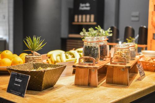 a table with jars of herbs and other food items at Novotel Liverpool Centre in Liverpool
