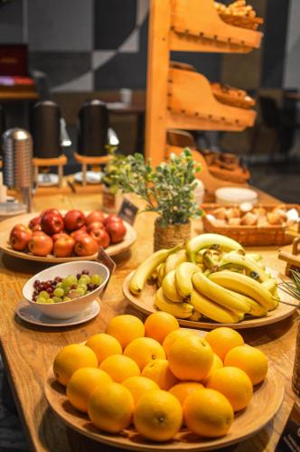 a table with plates of fruits and vegetables on it at Novotel Liverpool Centre in Liverpool