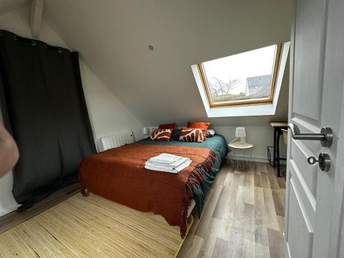 a small bedroom with a bed and a window at Charmante maison à 10 mn d'Angers in Corné