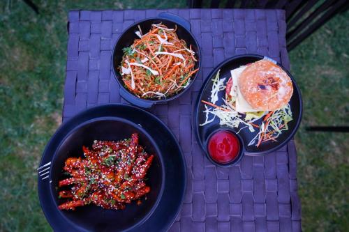 two plates of food on a purple table with food at Hide-In Rishikesh in Rishīkesh