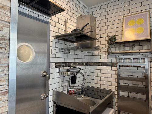 a small kitchen with a sink and a counter at Le Corsaire in Angers