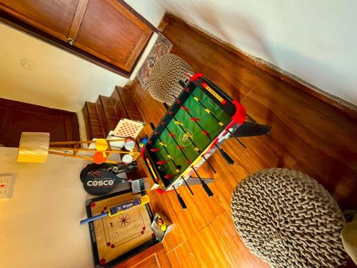 an overhead view of a pool table in a living room at Arameh-A Boutique Orchard Retreat Near Kasauli in Rājgarh