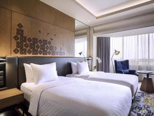 Ένα ή περισσότερα κρεβάτια σε δωμάτιο στο Mercure Jakarta Batavia