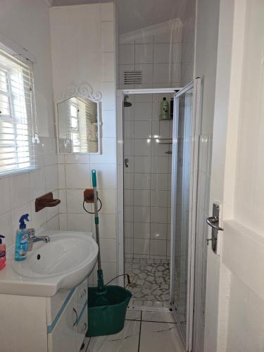 a bathroom with a shower and a sink and a shower at Valley Cottage in Kenton on Sea