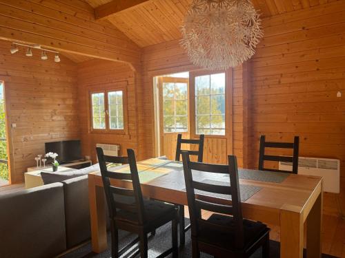 a dining room with a table and chairs and a chandelier at Seehaus Selina in Matfors