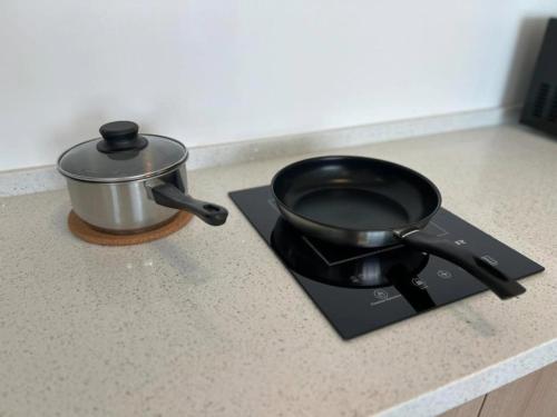 a pot sitting on top of a stove next to at Cozy Urban Suites Georgetown View in Jelutong
