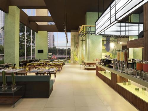 a restaurant with tables and chairs in a room at ibis Styles Jakarta Simatupang in Jakarta