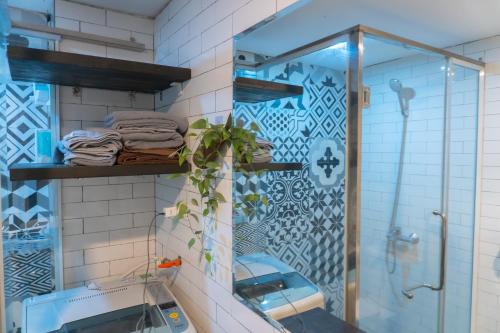 a bathroom with a shower and a mirror at Sure Home in Hanoi