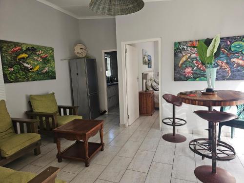 a living room with a table and chairs at Valley Cottage in Kenton on Sea