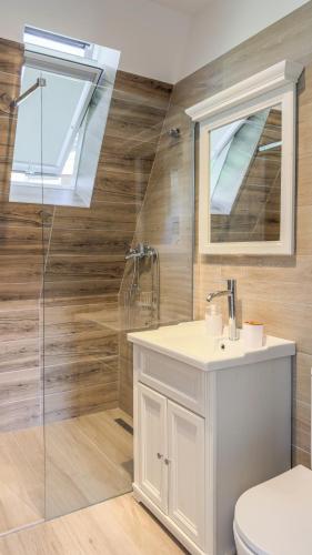 a bathroom with a toilet and a sink and a shower at A-Frame Valley in Buşteni