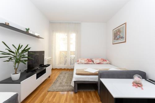 un soggiorno con due letti e una TV di Apartman Central Bliss Mostar a Mostar