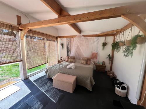 a bedroom with a bed and a large window at Grande Villa au vert à 1h de Paris #halloween #seminaire #sejour in Treuzy-Levelay