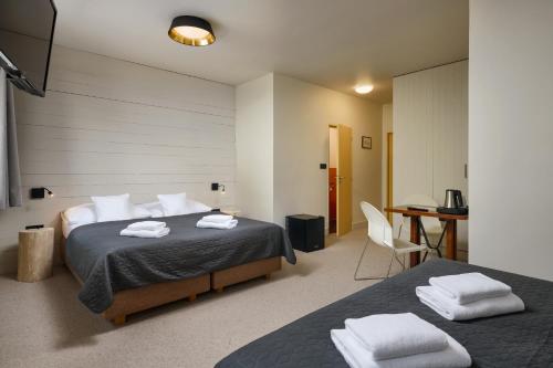 Postel nebo postele na pokoji v ubytování Hotel Adam