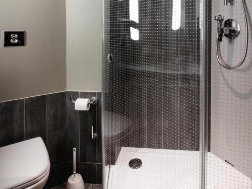 a bathroom with a shower and a toilet at ibis Cahors in Cahors