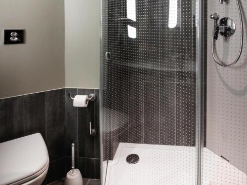 a bathroom with a shower and a toilet at ibis Cahors in Cahors