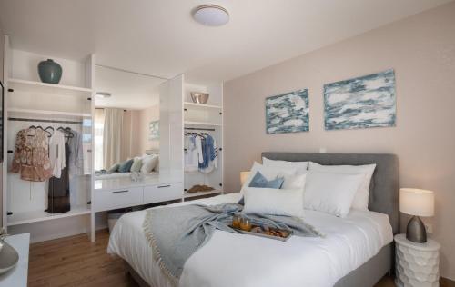a bedroom with a large bed and a dressing room at Luxury Villa San heated pool sauna in Sveti Filip i Jakov