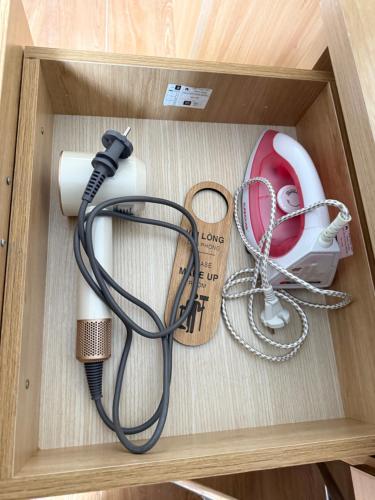 a box with a charger and a hair dryer and a wire at homestay halona in Phu Quoc