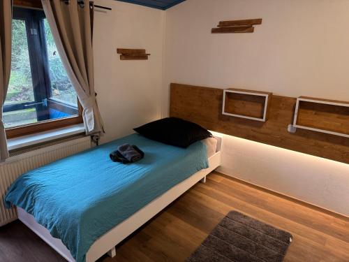 a bedroom with a bed with a bag on it at Hotel Albergo Trattoria Don Lillo Fewo in Idstein