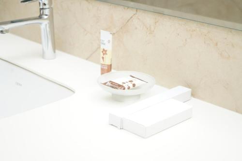 a bathroom with a sink and a bowl on a counter at VANTARA SUITEs in Vellore