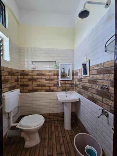a bathroom with a toilet and a sink at Lir-etso Homestay in Diphu