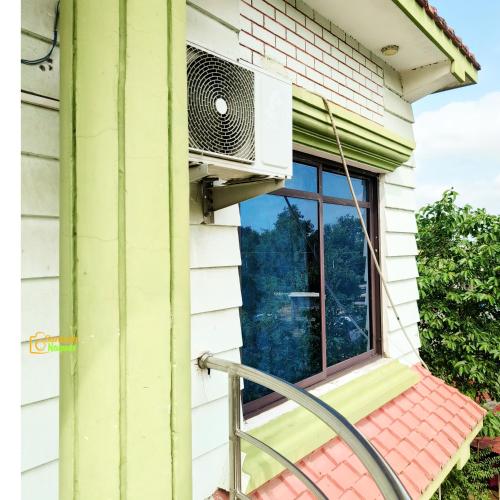 a window of a house with a air conditioner at Hotel Kailash in Lumbini