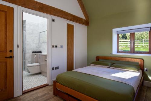 a bedroom with a bed and a bathroom at The Agora in Mollington