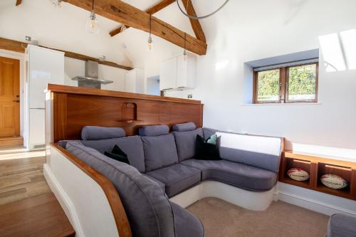 a living room with a couch in the middle at The Agora in Mollington