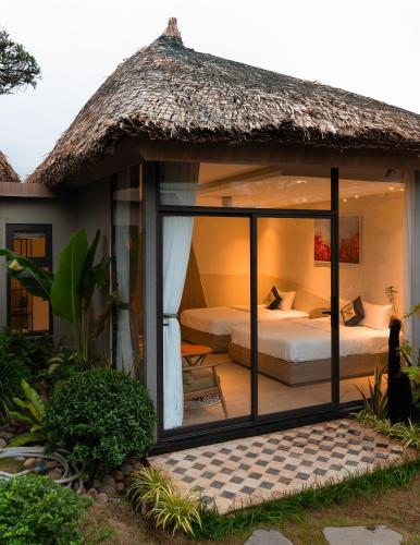 a room with a bed and a large window at An Tùng Retreat in Long Trường
