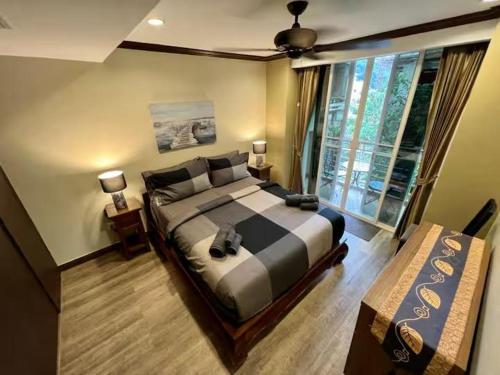 a bedroom with a large bed and a window at Karon Beach Seaview Penthouse With Private Pool Condominium in Karon Beach