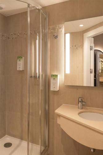 a bathroom with a shower and a sink at Best Western Au Trocadéro in Paris