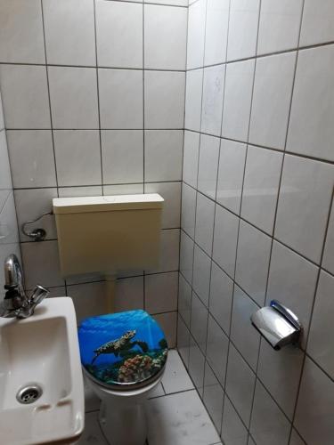 a small bathroom with a toilet and a sink at FEWO Laubwald in Sögel