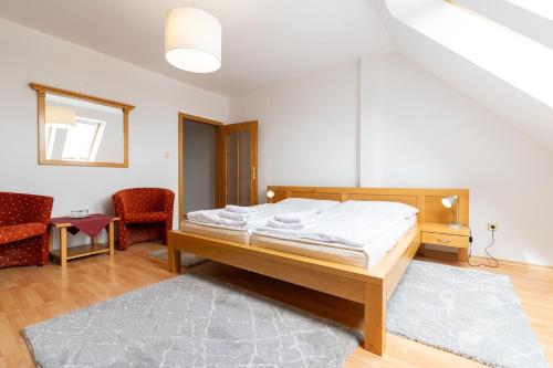 a bedroom with a bed and a living room at Hotel Arkada in Levoča