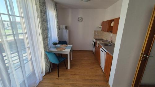 a small kitchen with a table and a sink at Apartmán Nový Svět in Třeboň II