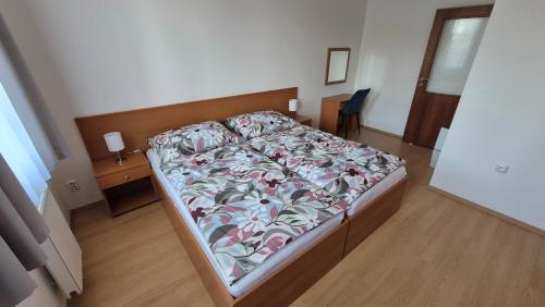 a bedroom with a bed and a desk with a chair at Apartmán Nový Svět in Třeboň II