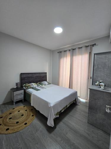 Tempat tidur dalam kamar di Residence Sunset