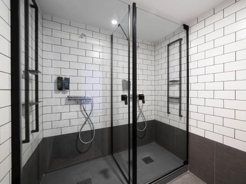 a shower with a glass door in a bathroom at ibis Porto Centro Mercado Bolhao in Porto