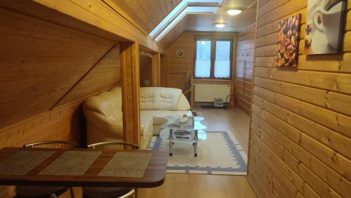 a living room with a couch and a table at Wiślany Raj in Wisła