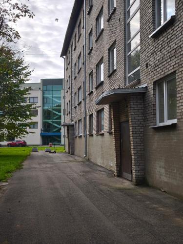 an empty street next to a brick building at Narva Boho Home in Narva
