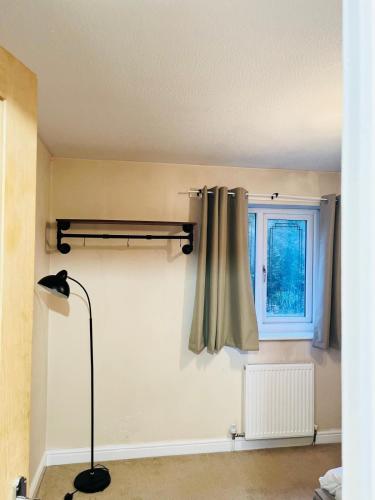 a room with a curtain and a window at Two bedroom home in quite culdisac over looking hospital in Blackburn