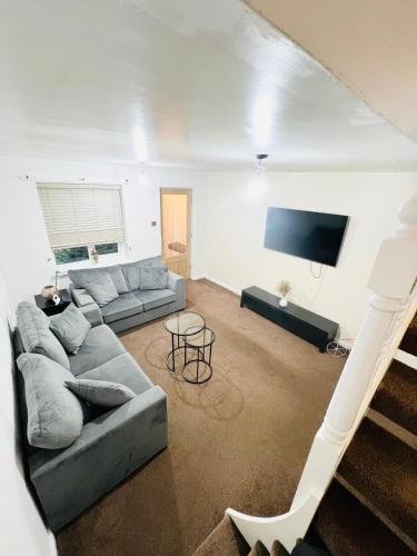 a living room with a couch and a tv at Two bedroom home in quite culdisac over looking hospital in Blackburn