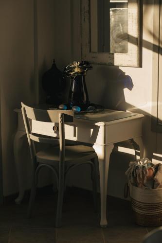 a white desk with a chair and a vase on it at Kea Villa Thea by A&D Properties in Otzias