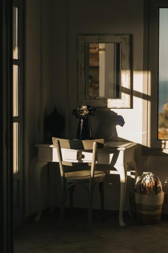 a desk with a mirror and a chair in a room at Kea Villa Thea by A&D Properties in Otzias