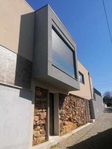 a house with a window on the side of it at Casa Gonzaga in Amarante
