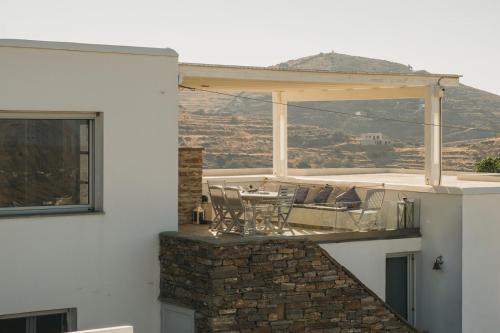 a patio with a table and chairs on a building at Kea Villa Thea by A&D Properties in Otzias