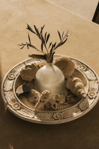 a white vase sitting on a plate on a table at Kea Villa Thea by A&D Properties in Otzias