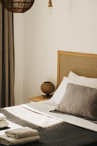 a bedroom with a bed with two towels on it at Kea Villa Thea by A&D Properties in Otzias
