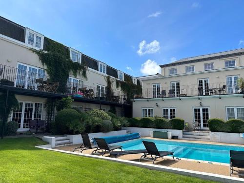 a swimming pool in front of a building at The Albany Apartments in St Peter Port
