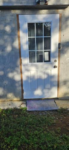 a front door of a house with a window at Bed & Shower Stop in East End