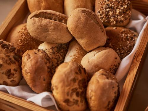 a wooden box filled with different types of bread at A-ROSA Kurhaus Binz in Binz