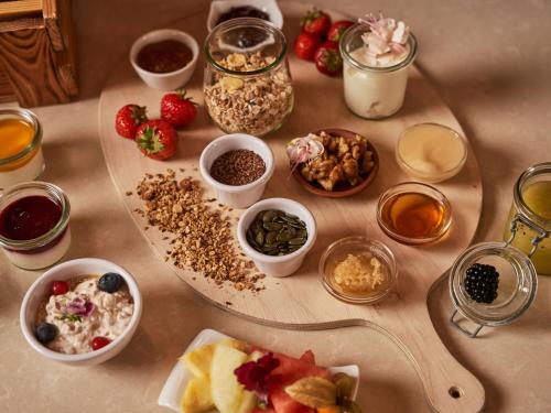 a table topped with bowls of food and other ingredients at A-ROSA Kurhaus Binz in Binz